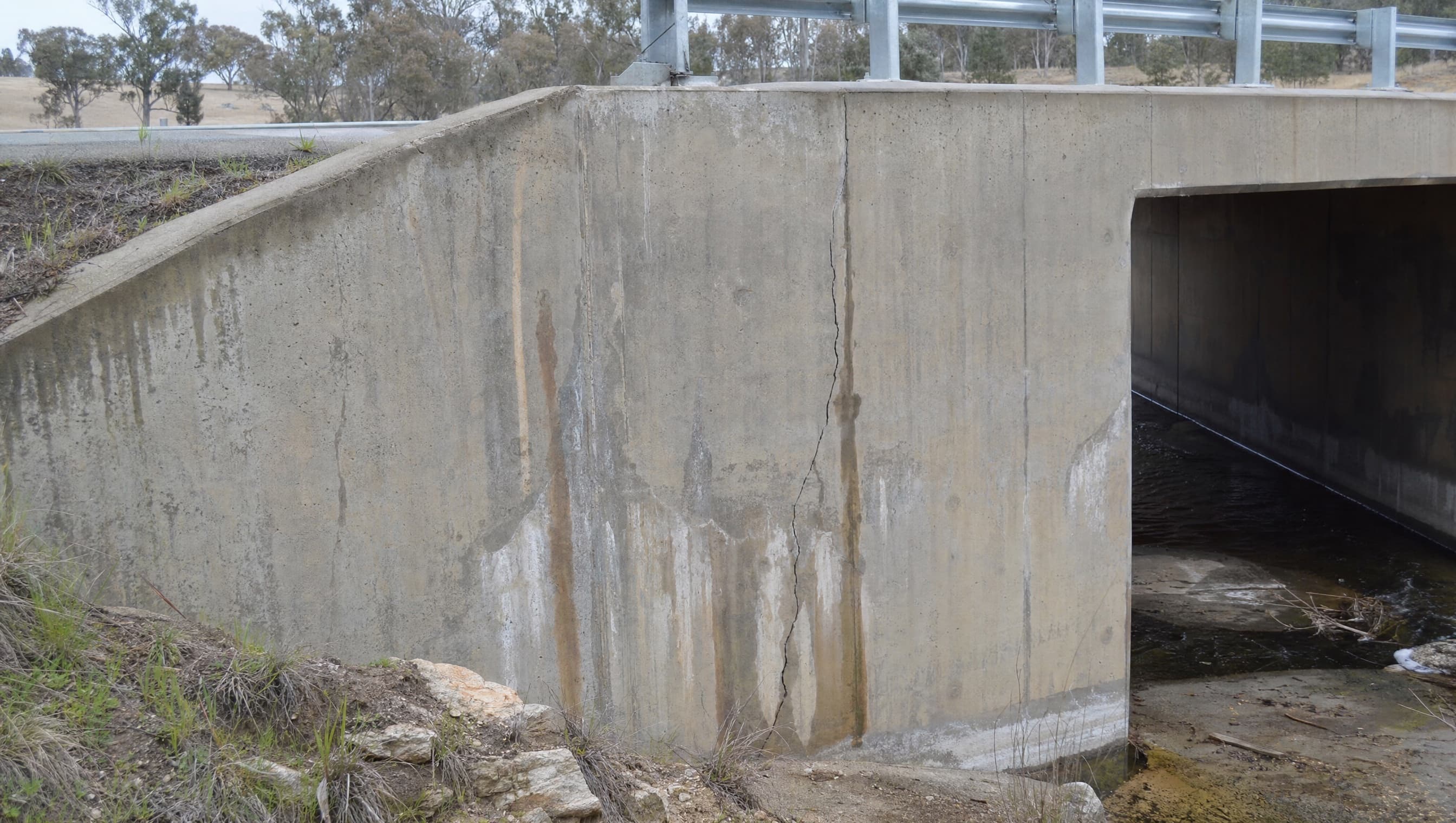 Source frame showing visible cracking on a concrete culvert headwall.